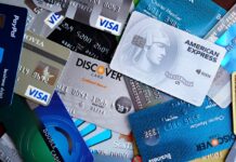 The Hidden Cost of Credit Card Rewards (And How Disciplined Users Benefit) A variety of credit and debit cards spread out on a surface