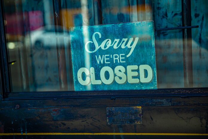 A 'Sorry We're Closed' sign displayed in a window