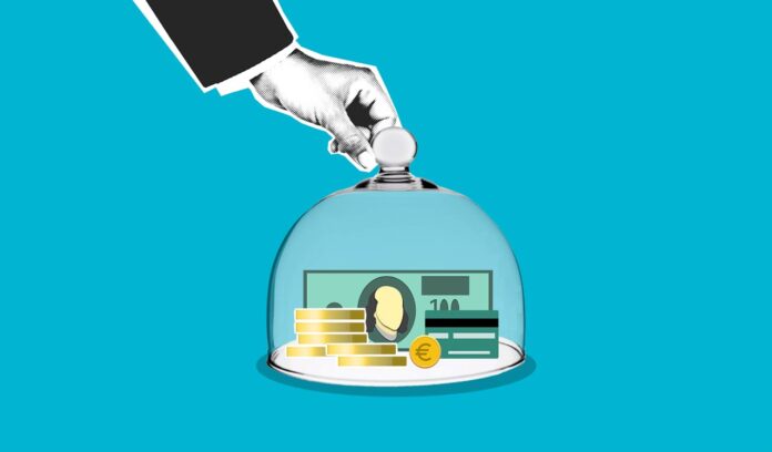 pexels-gabby-k-5849554.jpg A hand placing a dome over cash and coins on a blue background
