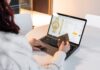 Buy Now, Pay Later: The Financial Trap Hiding in Plain Sight Person holding a credit card while shopping online for a watch on a laptop