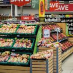 Smart Grocery Strategies That Help Families Eat Well on Less Display of apples in a grocery store with sale signs