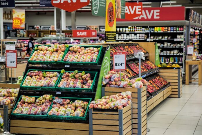 pexels-pixabay-264636.jpg Display of apples in a grocery store with sale signs