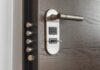 The Home Security Boom: Fear, Data, and the Fortress Mentality Close-up of a modern door lock and handle