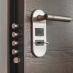 The Home Security Boom: Fear, Data, and the Fortress Mentality Close-up of a modern door lock and handle