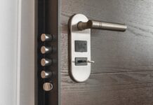 The Home Security Boom: Fear, Data, and the Fortress Mentality Close-up of a modern door lock and handle