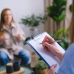 Why Businesses Are Finally Replacing Gut Decisions With Proven Prioritization Person taking notes during an interview with another individual in a cozy setting